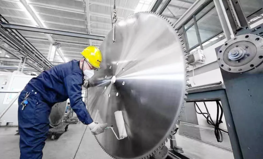 An industrial blade being examined closely, highlighting its precision and durability in a manufacturing setting.